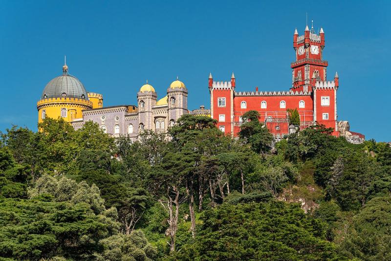 The yellow and red towers of Pena Palace, Sintra, wrapped in mist